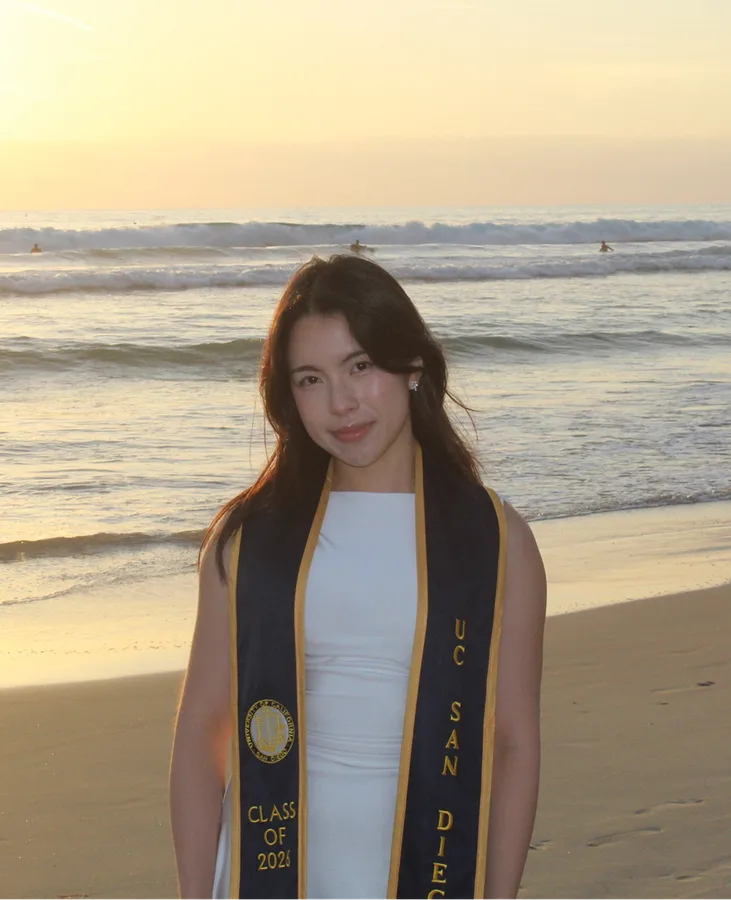 Allison Huang at the beach in a UC San Diego graduation stole